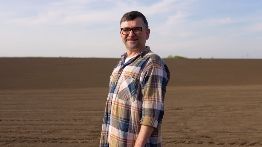 Senior farmer is checking soil quality before sowing
