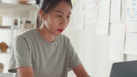 Close-up Young Asia girl IT development programmer typing on keyboard coding programming fixing data code on laptop computer screen follow code plan in tablet and paperwork on table at house office. - Powered by Shutterstock - Get 15% off with code: PIKWIZARD15
