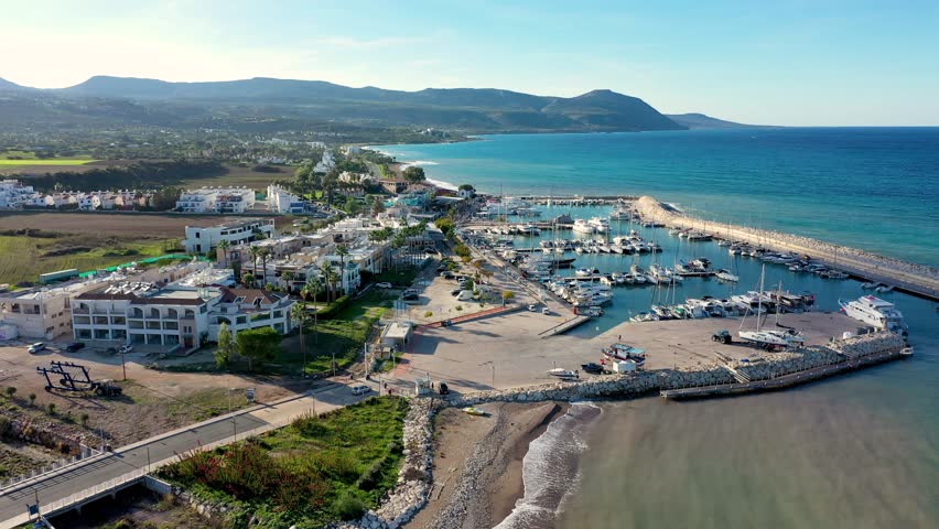 View of Latchi port, Akamas peninsula, Polis Chrysochous, Paphos, Cyprus. The Latsi harbour with boats and yachts, fish restaurant, promenade, beach tourist area and mountains, Latchi, Cyprus.