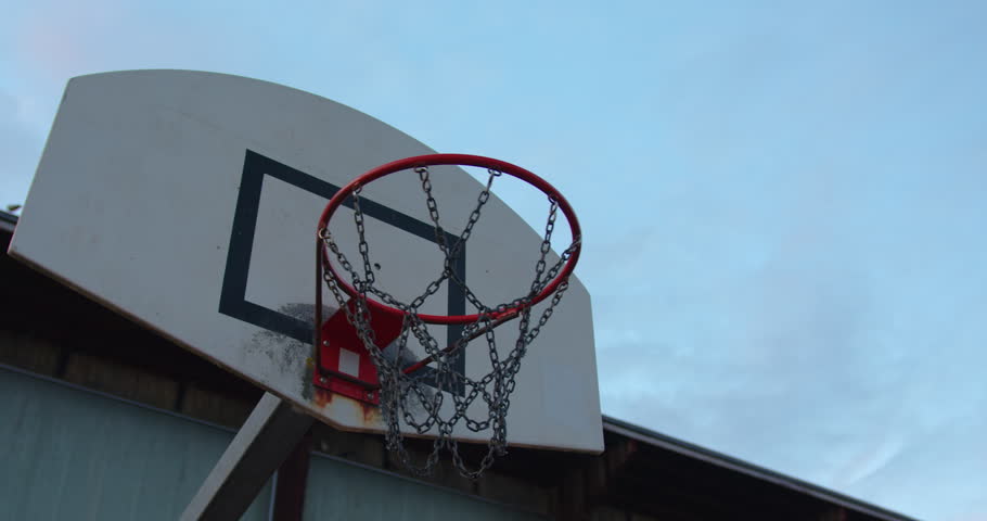 Basketball flying into the basketball hoop. Footage of a ball flying into the basket. Slow motion video from below the basket with the ball flying in. Goal Royalty-Free Stock Footage #1103618559