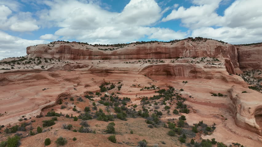 Aerial red rock desert southern Utah highway slide 2. Moab in south eastern Utah desert. Erosion in red sandstone, arches and canyons. Nearby Arches and Canyonlands National Parks. Red rock mountain. Royalty-Free Stock Footage #1103619361