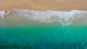 Aerial drone video. Beautiful tropical beach with sand and turquoise water. Top view of an empty and clean beach. Mediterranean Sea, Türkiye.