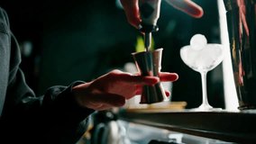 A professional bartender pours alcohol into a measuring cup The process of making cocktails in a club in bar close-up - Powered by Shutterstock - Get 15% off with code: PIKWIZARD15