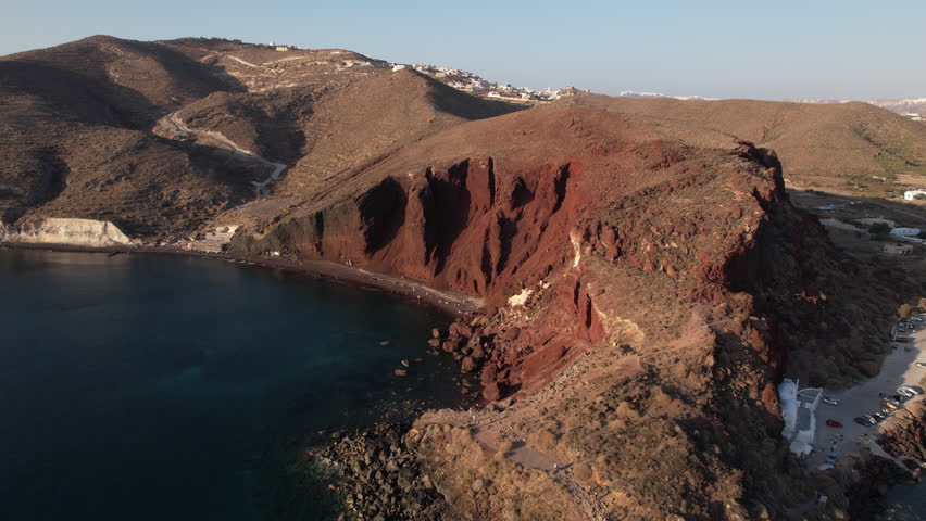 Aerial View of Santorini Island Greece Coastline and Red Beach on Sunny Evening, Drone Shot