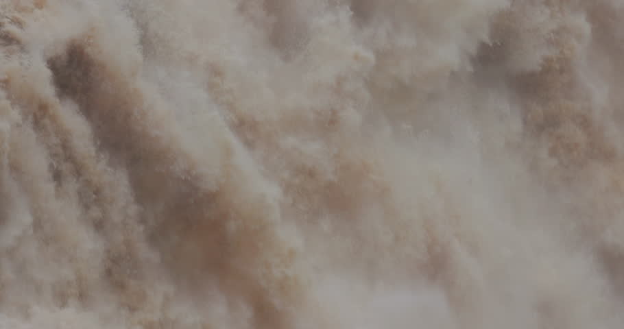 Close up water rushing down waterfall at Barron Falls in Cairns, Australia.