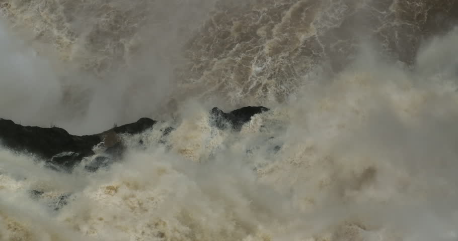 Close up of water rushing down Barron Falls Waterfall in Far North Queensland during wet season.