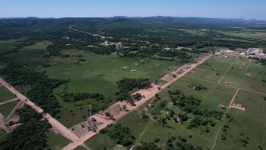 aerial view of land and houses in the middle of the forest. Nature Retreat: Building Sites Surrounded by Natural Beauty"