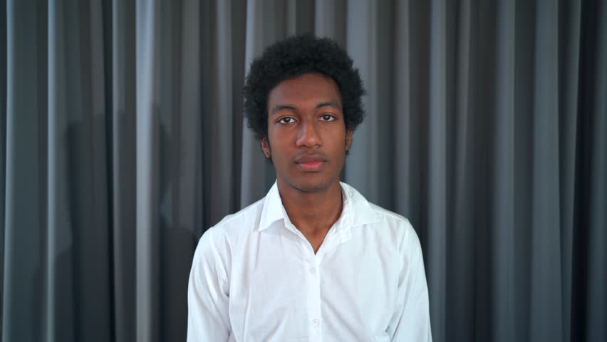 Happy young boy smiling and blinking to camera with confident. Good looking and smart university student portrait.