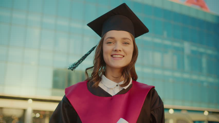 Portrait of Graduate Girl in the Mantle Happy About Getting a Diploma. Young Woman in Graduation Gown Rejoicing Her Diploma. Alumni of Educational Institutions. Concept of Future Leaders Royalty-Free Stock Footage #1103639147