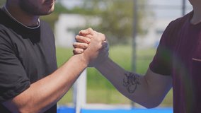 Four young padel tennis players shaking hands after a match. Sporty handshake. - Powered by Shutterstock - Get 15% off with code: PIKWIZARD15