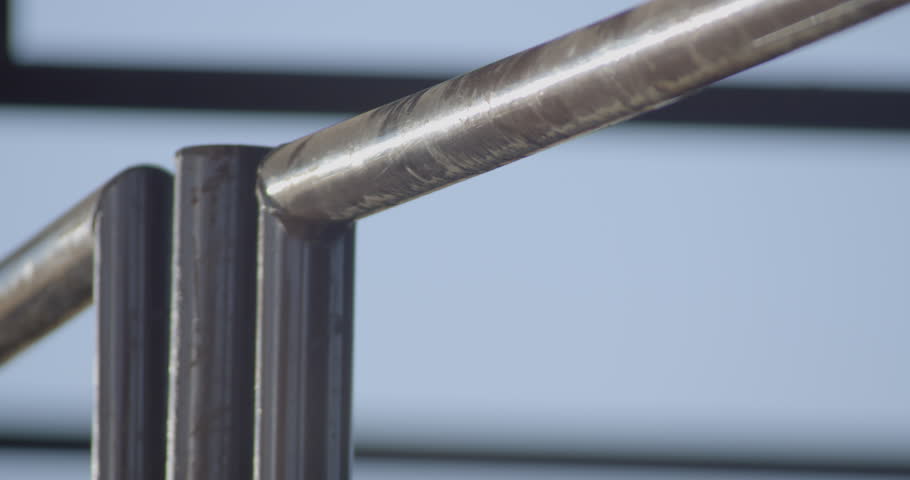 Cowboy ties his bull rope to the metal chute to warm it up before a bull riding rodeo.