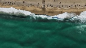 Static vertical aerial footage drone video top view stormy beach graphic art shadows on the sand.Aerial footage of wind storm on the beach. Drone video of wind destroying the beach.
