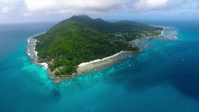 Aerial View of Seychelles La Digue Island with Sandy Shore and Covered with Green Forest Trees Among the Tropical Indian Ocean with Turquoise Blue Water. Paradise Beach. Video Background. UHD 4K