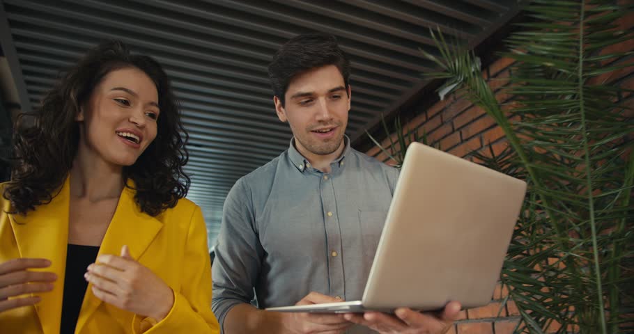Dynamic Office Team: Collaborating for Success. Two employees walk around the office and discuss current topics Royalty-Free Stock Footage #1103658621