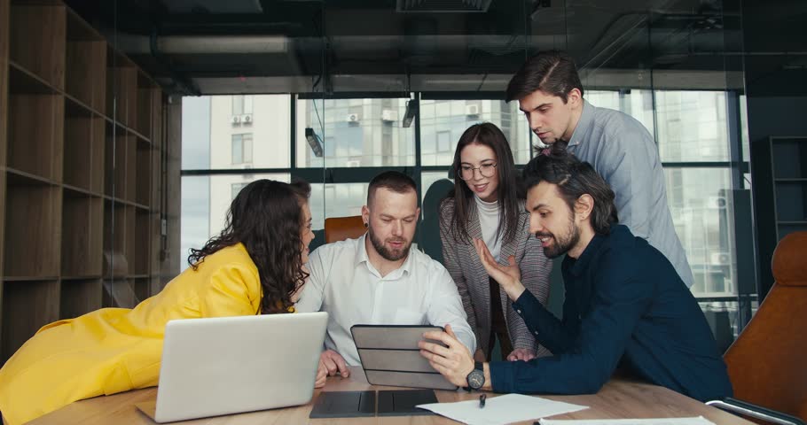 Teamwork, the path to success and Overcoming difficulties along the way. A young office worker explains to his colleagues the essence of the topic of conversation Royalty-Free Stock Footage #1103658625