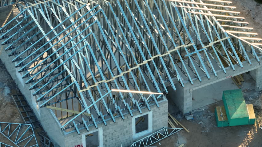 Aerial view of unfinished residential house with metal roof frame structure under construction in Florida suburban area. Development of american housing concept Royalty-Free Stock Footage #1103659881