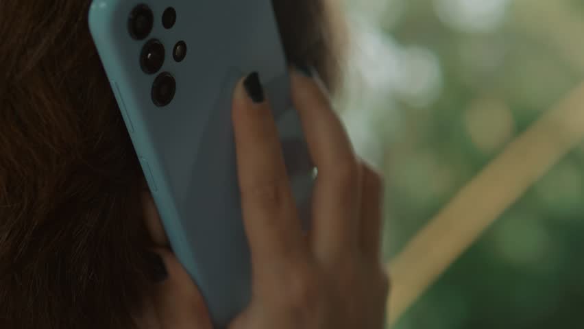 Woman head talking on smartphone. Back view. Close up. Royalty-Free Stock Footage #1103663185