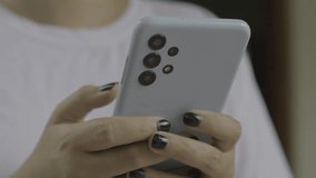 Close up of woman hands typing on smartphone.