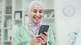 Closeup pretty muslim arabic business woman using smartphone typing chatting scrolling surfing web holding mobile phone on workplace office Indoor Happy employee worker in hijab uses app Close up - Powered by Shutterstock - Get 15% off with code: PIKWIZARD15