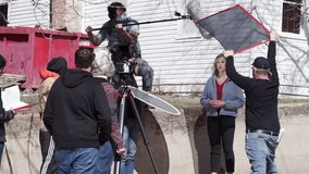Behind the scenes of a news reporter talking to a professional camera, film set