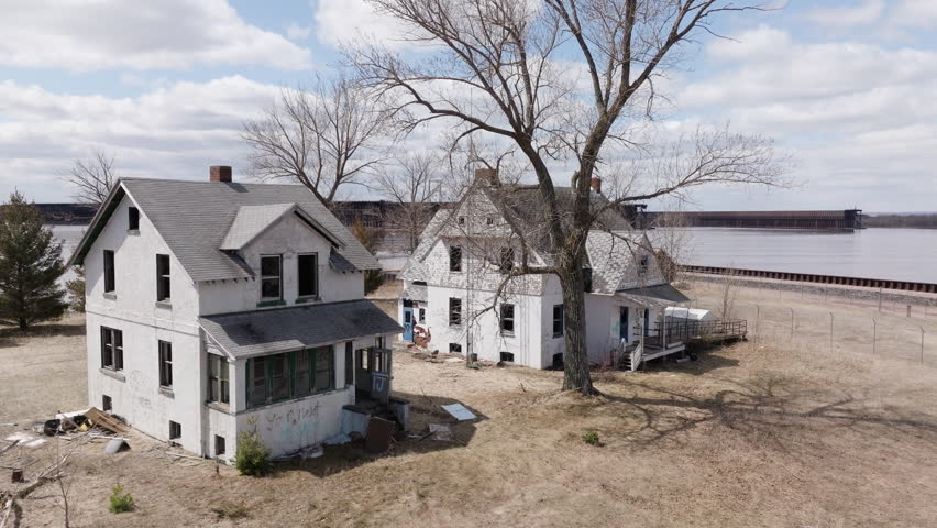 Dilapidated, abandoned homes sit vacant along waterfront property at Wisconsin Point on Lake Superior