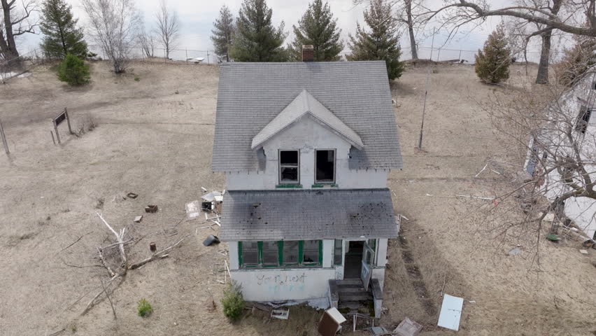 Old, decrepit houses sit empty on vacant waterfront property on Wisconsin Point along Lake Superior