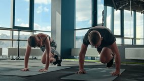 Caucasian sportsman man sportswoman woman sporty bodybuilders doing mountain climber exercise running plank on fitness mat lifting up muscular legs burn energy loss weight cardio workout in sport gym - Powered by Shutterstock - Get 15% off with code: PIKWIZARD15