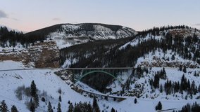 Aerial Cinematic drone Vail Avon Red Cliff Iconic Colorado Bridge mid winter cars driving in snow late sunset pan forward movement - Powered by Shutterstock - Get 15% off with code: PIKWIZARD15