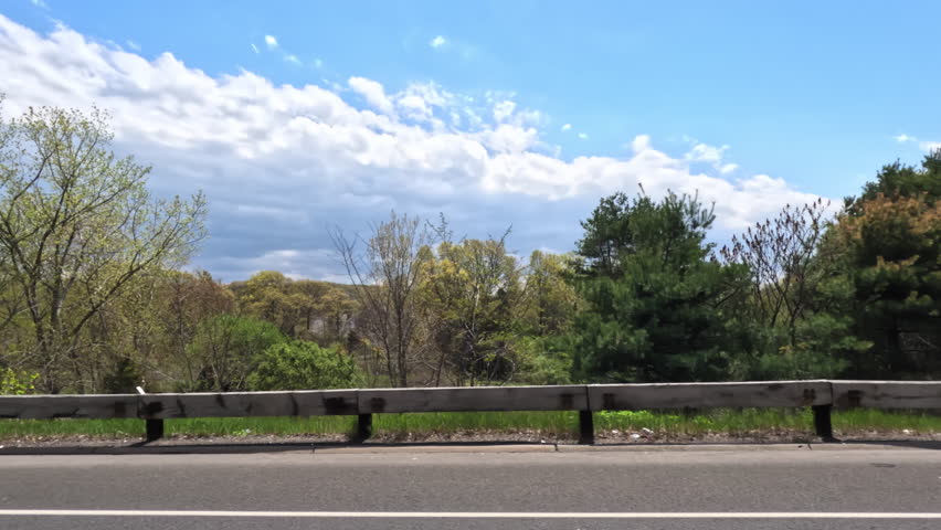 Pov side point of view of driving in car vehicle road trip with forest . wide shot footage