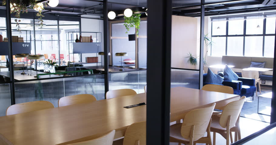 Empty office, modern workplace or space with furniture in work building. Corporate conference or business meeting room, chairs or tables for workshop and set up or interior design for boardroom Royalty-Free Stock Footage #1103686701