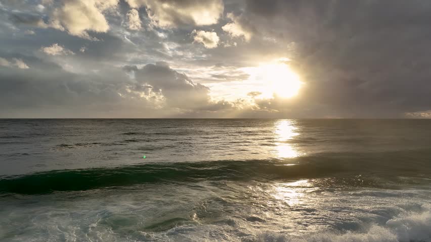 Beautiful aerial view of the sunsets over sea. Ocean beach sunrise and dramatic colorful sky clouds Beautiful sea waves and white sand beach in the Turkish city.