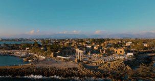 Aerial drone video of the ancient Apollo Temple in Side, Antalya, Turkey, captured during a stunning sunset, showcasing the beautiful historical landmark and surrounding landscape.