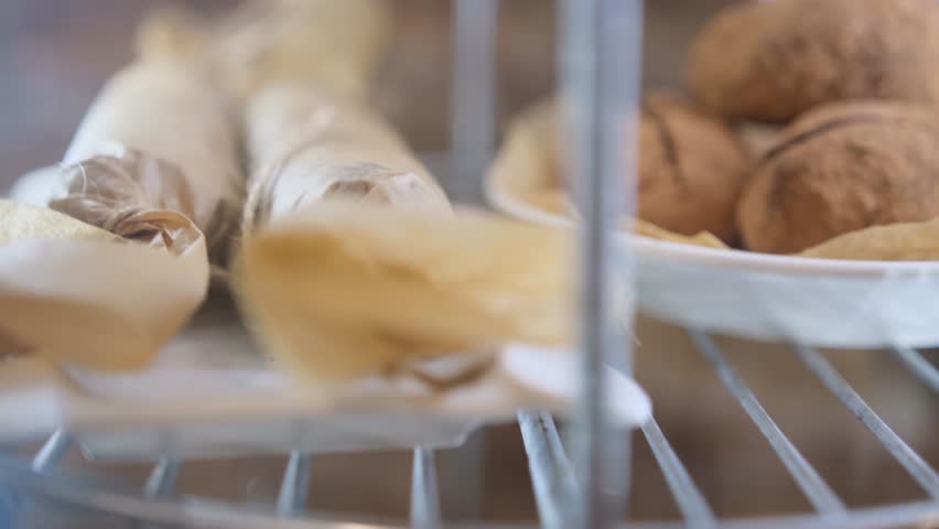 cakes and cupcakes in the window behind the glass slowly rotate