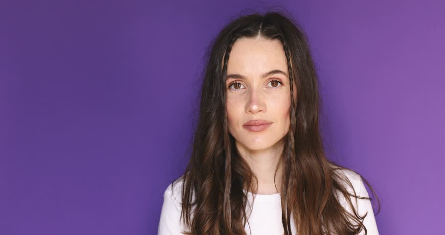 Happy woman looking camera shocked surprised say wow, spread hands. Wow, it is awesome. Surprised girl face. Close up of shocked woman face expression. Woman with braids wear white t-shirt.