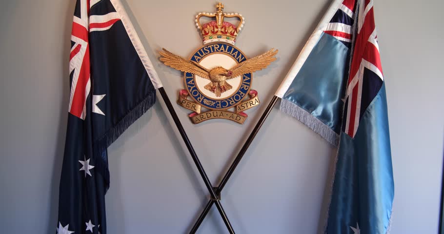 Point Cook VIC Australia-May 11 2023: the airforce badge of Royal Australian Air Force between a Royal Australian Air Force Ensign flag and the flag of Australia in RAAF Musum.