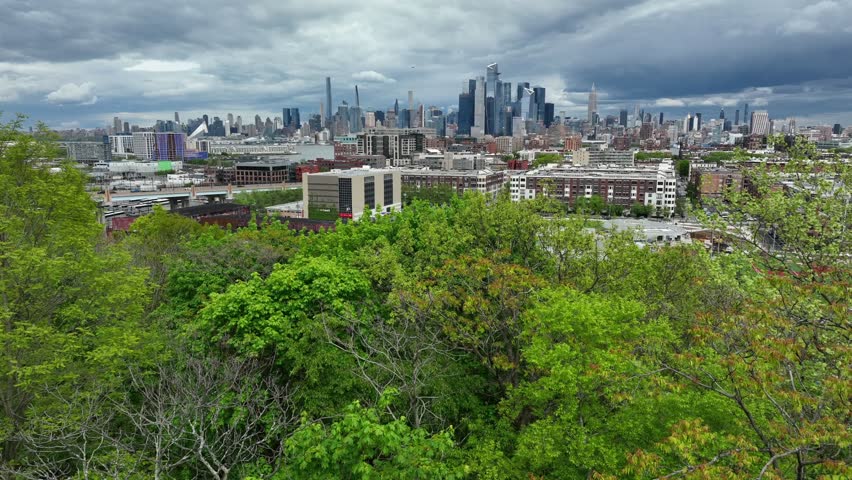 Midtown Manhattan NYC skyline as seen from Hoboken New Jersey USA. Aerial view above trees.