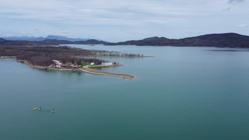 Small peninsula with a cafe in lake Plastira, central Greece. Drone shot of lake