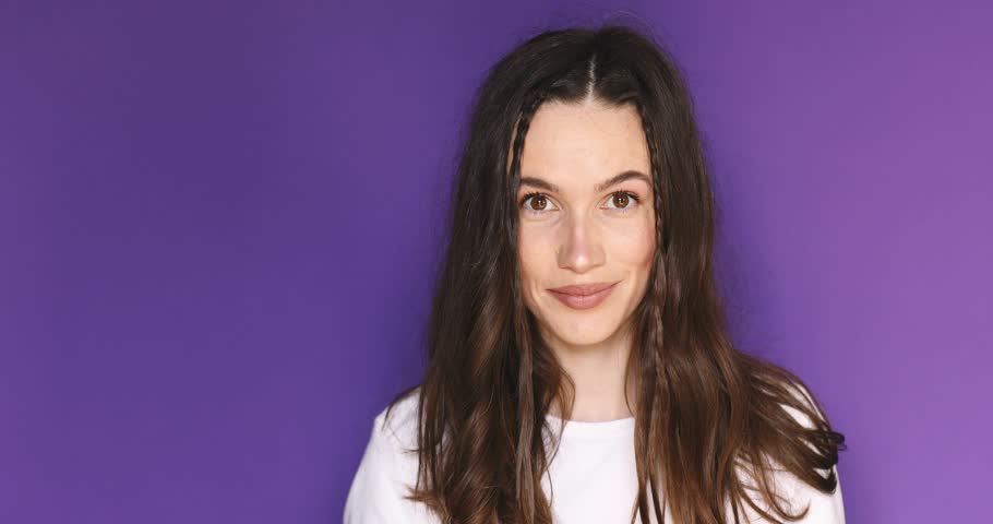 Happy woman looking camera shocked surprised say wow, spread hands. Wow, it is awesome. Surprised girl face. Close up of shocked woman face expression. Woman with braids wear white t-shirt.
