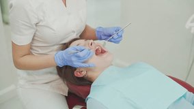 The hands of a female dentist during an examination of a patient's teeth in a modern dental clinic. Dentistry - Powered by Shutterstock - Get 15% off with code: PIKWIZARD15