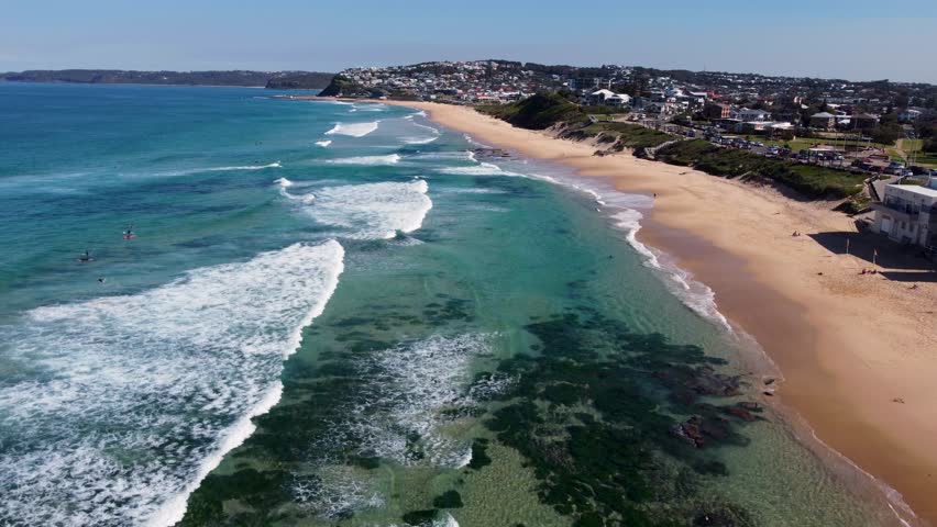 Aerial drone landscape view pan of Merewether Beach surfing clear ocean sea beach travel tourism Newcastle NSW Australia coastline 4K