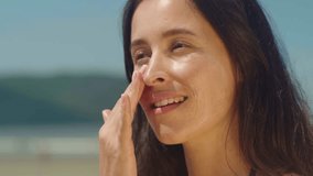 Close-up woman on bikini takes sunscreen of tube, moisturizing lotion applies sunblock on her face
 - Powered by Shutterstock - Get 15% off with code: PIKWIZARD15