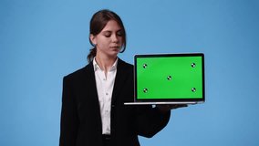 4k video of one girl using chroma key laptop and showing thumbs down over blue background.