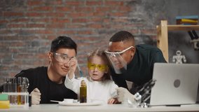 Little girl drips blue liquid using pipette into flask with dark green material at tutors support in scientific laboratory - Powered by Shutterstock - Get 15% off with code: PIKWIZARD15