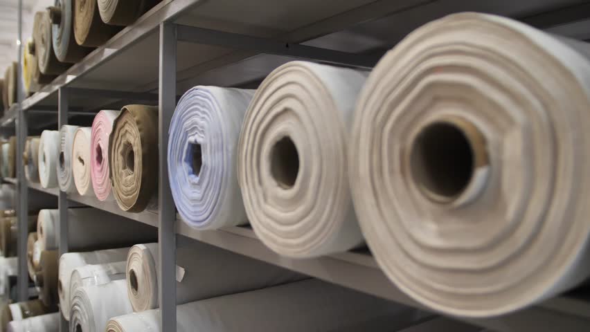 Textile factory. spinning of the fabric roll.  A large warehouse of textile products and goods. Sewing or furniture production.