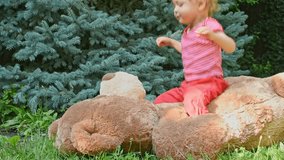 Happy little child having fun jumping on his giant teddy bear - Powered by Shutterstock - Get 15% off with code: PIKWIZARD15