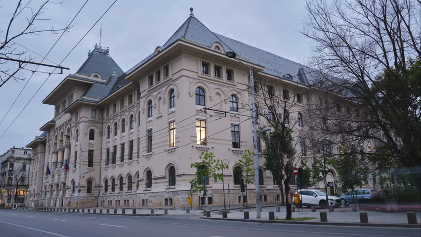 Bucharest town hall building with car traffic in day to night timelapse. Administration landmark in Romania capital city.