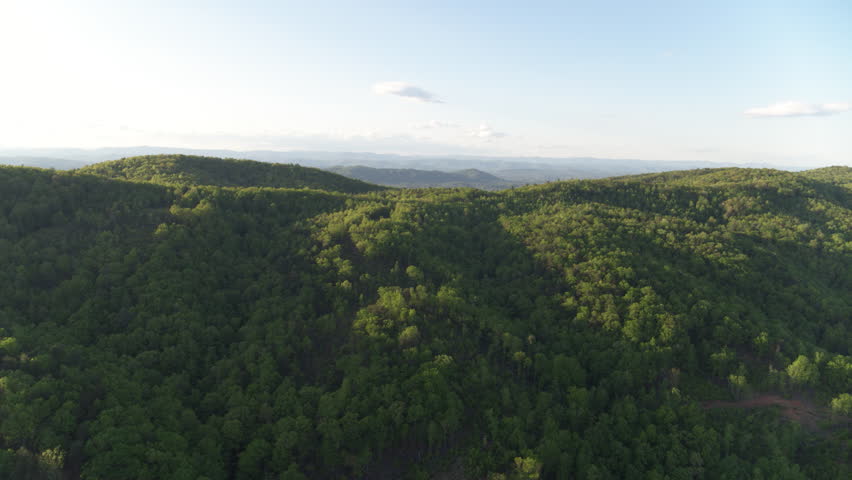 Wide aerial view of North Carolina Appalachian mountains in Pisgah Forest at sunset in spring time