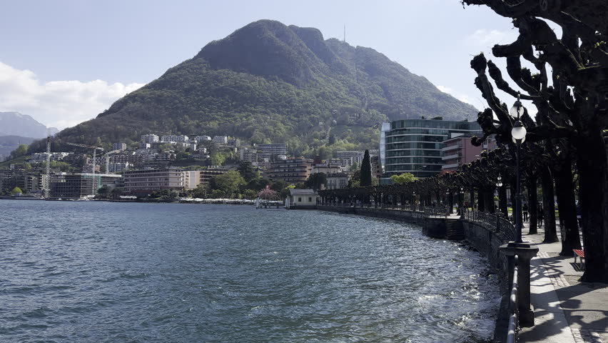 Static view of Lugano lake with its overlooking city. Switzerland
