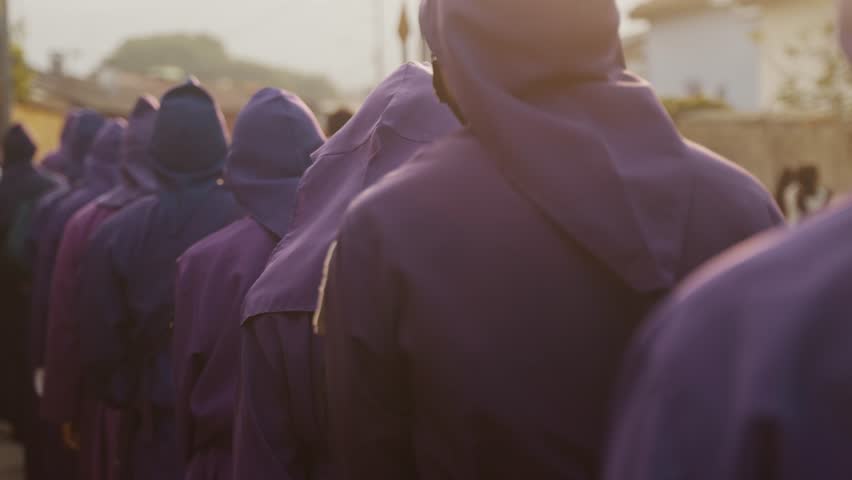 Easter Sunday Of Holy Week Celebration With Men In Purple Hooded Robes In Antigua, Guatemala. Slow Motion