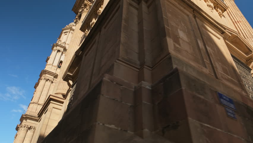 Malaga Cathedral in Andalusia, Southern Spain. Steadicam revealing footage of the magnificent Cathedral of the Incarnation of Malaga at sunny summer day  Royalty-Free Stock Footage #1103757281